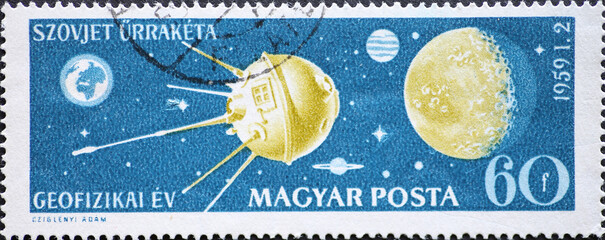 Hungary circa 1959: A post stamp printed in Hungary showing a Space probe approaching moon during...