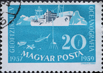 Hungary circa 1959: A post stamp printed in Hungary showing a Deep sea exploration: research vessel and iceberg during the International Geophysical Year