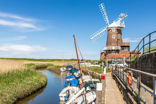 The early 19th century Cley Windmill beside the River Glaven in the village of Cley next the Sea, Norfolk UK