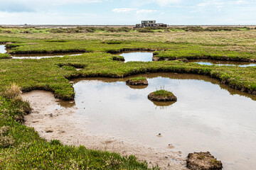 An old derelict boat beside the River Glaven on the salt marshes at Blakeney National Nature...