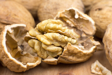 Crushed Walnut on the wood background. Close up.