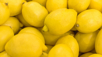 A lot of golden lemon, texture background. Pile of fresh ripe lemon pattern, high quality photo