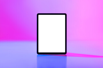 Modern tablet computer with mockup for application or website on blank white screen in neon light