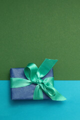 Christmas gift box on abstract paper background.
