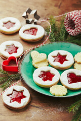 Classic Linzer Christmas Cookies with raspberry or strawberry jam on wooden table