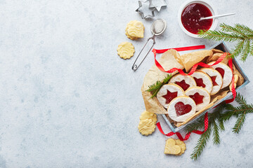 Classic Linzer Christmas Cookies with raspberry or strawberry jam on light background.
