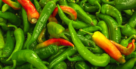 A lot of hot chili peppers, texture background. Pile of fresh ripe green chili peppers pattern, high quality photo