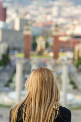 Unrecognizable back girl with blonde hair at the Montjuic viewpoint in Barcelona (Spain).