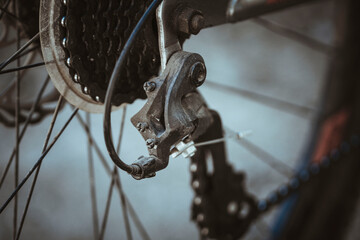 Obraz premium Bicycle elements in close-up. Individual parts of a sports bike are in focus. The vehicle parts are covered with dust