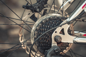 Obraz premium Bicycle elements in close-up. Individual parts of a sports bike are in focus. The vehicle parts are covered with dust