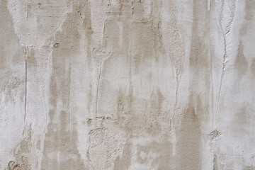 The texture of a gray concrete wall. The background of old cement plaster. Gray wall surface