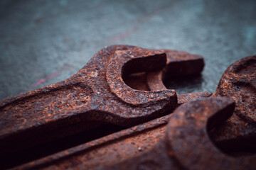 Vintage wrenches covered with rust on a dark background