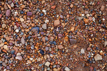 river sand with brown stones of different sizes