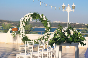 Wedding flower arch with white flowers. Beautiful wedding set up Area of the wedding ceremony. 