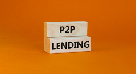 P2P peer to peer lending symbol. Concept words P2P lending on wooden blocks on a beautiful orange background. Business and P2P peer to peer lending concept. Copy space.
