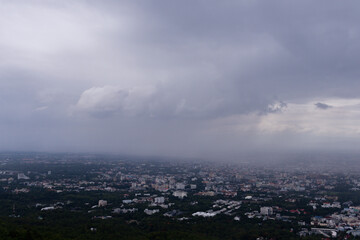 The view from the top of the mountain to see the beautiful scenery of Chiang Mai during the rainy season makes it possible to see the rain cloud and rain that are falling towards Chiang Mai city.
