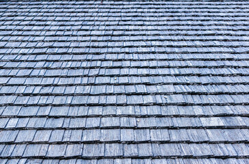 Closeup of the area of an old village roof made of wooden shingles.