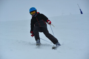 Boy down the snow skiing