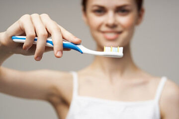 woman with a toothbrush in hand morning hygiene studio lifestyle