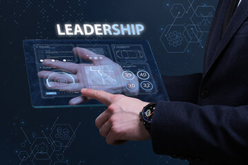 Business, Technology, Internet and network concept. Financial Graph. Stock Market chart. Young businessman working on a virtual screen of the future and sees the inscription: Leadership