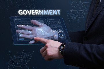 Business, Technology, Internet and network concept. Financial Graph. Stock Market chart. Young businessman working on a virtual screen of the future and sees the inscription: Government