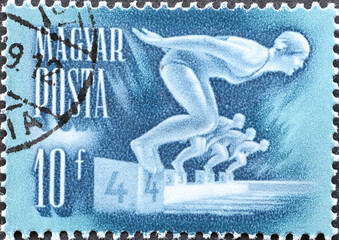 Hungary circa 1950: A post stamp printed in Hungary showing sporting activities: some girls jump...