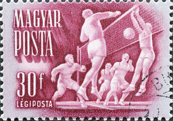 Hungary circa 1950: A post stamp printed in Hungary showing sporting activities: volleyball  game...