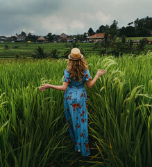 Girl in dress walking in rice fields in Bali