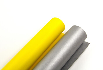 Paper rolls of different colors on a white background.