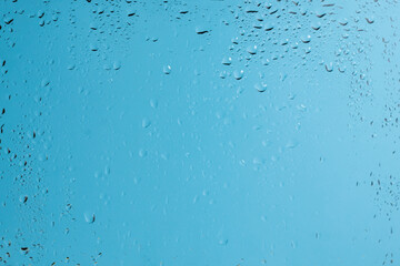 Blue backgrond with water drops. Wet glass.