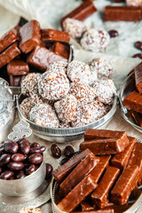 Assorted chocolate candies on wooden background. Chocolate sweets. Dessert background.