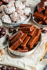 Assorted chocolate candies on wooden background. Chocolate sweets. Dessert background.