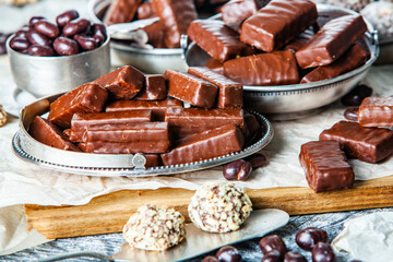 Assorted chocolate candies on wooden background. Chocolate sweets. Dessert background.