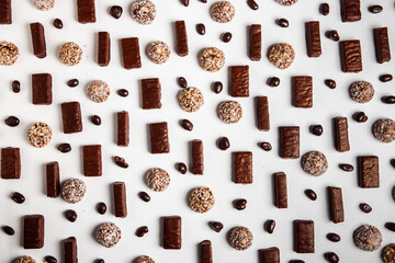 Assorted chocolate candies on wooden background. Chocolate sweets. Dessert background.