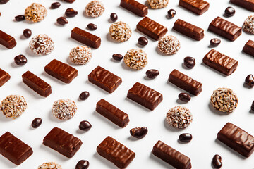 Assorted chocolate candies on wooden background. Chocolate sweets. Dessert background.