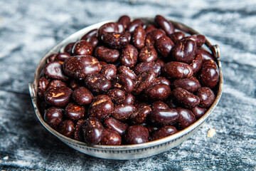 Assorted chocolate candies on wooden background. Chocolate sweets. Dessert background.