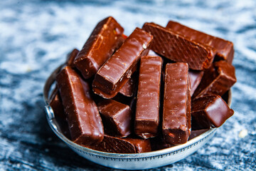 Assorted chocolate candies on wooden background. Chocolate sweets. Dessert background.