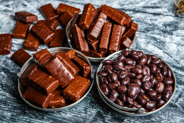 Assorted chocolate candies on wooden background. Chocolate sweets. Dessert background.