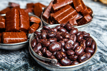 Assorted chocolate candies on wooden background. Chocolate sweets. Dessert background.
