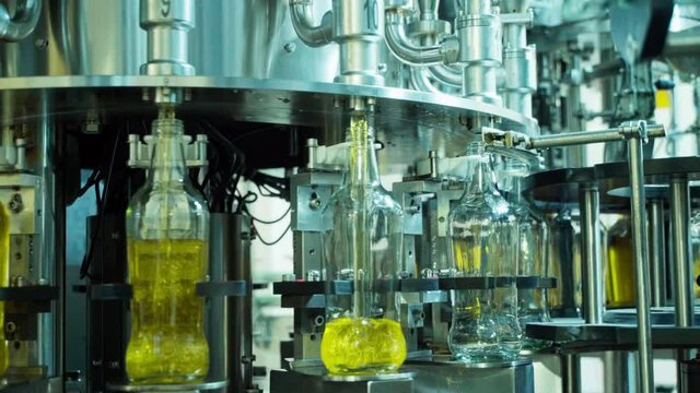 Extra virgin olive oil bottles being filled up at the bottling plant