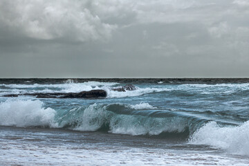 Rough waves rolling in at Atlantic Guincho beach in Portugal