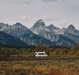 white camper van parked in front of mountains