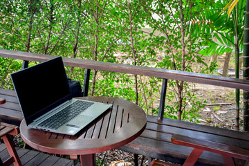 Laptop with blank screen on table.