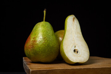Pears on a black background. Pear cut in half. Healthy diet