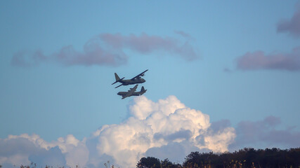  Two crossing overlapping British RAF Lockheed Martin C-130J Hercules aircraft on a military exercise cargo parachute drop run over Salisbury Plain Training Area, UK