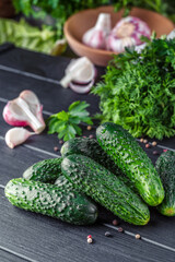 Cucumber on  dark wood texture background.Cucumbers harvest in summer. Cucumbers for salads or canning. Summer vegetables. Organic agriculture in village.