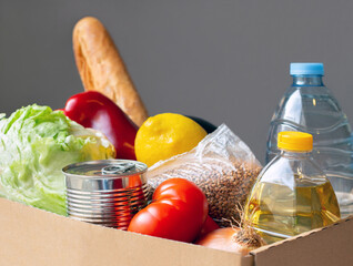 A set of products is in a cardboard box on the table. The topic is essential products.	
