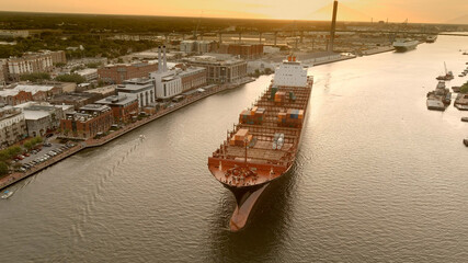 A large container ship leaves the port of Savannah after offloading its cargo.