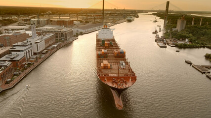 A large container ship leaves the port of Savannah after offloading its cargo.