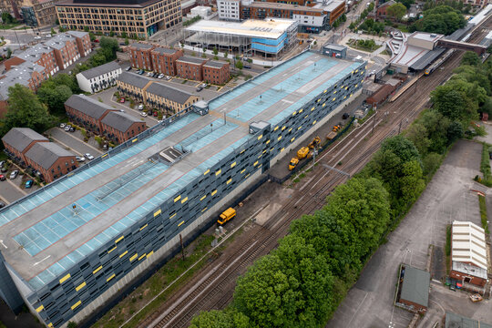 Aerial drone photo of the town centre of Wakefield in West Yorkshire in the UK showing a multi-story car park next to the train station